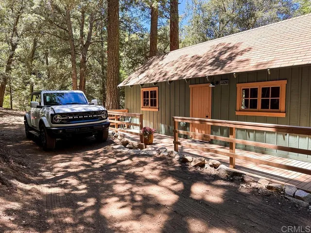 a backyard of a house with yard and outdoor seating