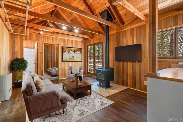 a living room with furniture a rug and a flat screen tv