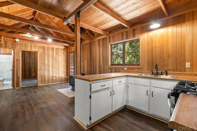 a kitchen with a sink window and cabinets