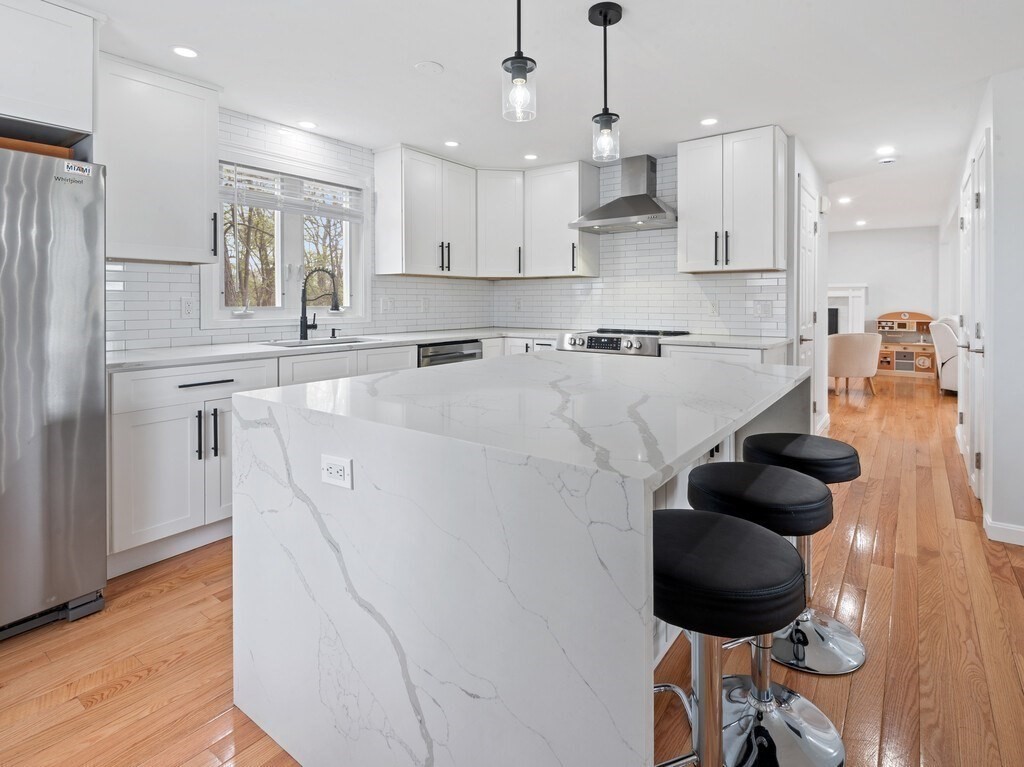 2 Stringer Dam Road Shrewsbury, MA 01545 - Photo 13 of 35 a kitchen with stainless steel appliances granite countertop a sink a stove a refrigerator and white cabinets with wooden floor
