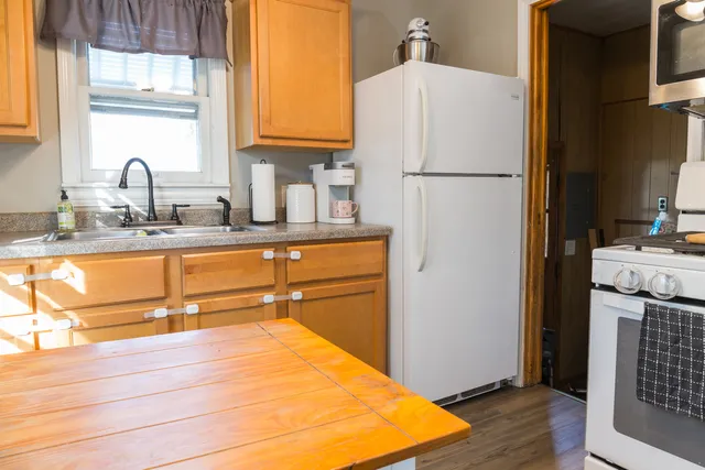 a kitchen with a refrigerator sink and cabinets