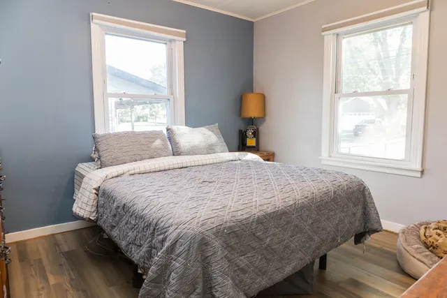 a large bed sitting in a bedroom next to a window