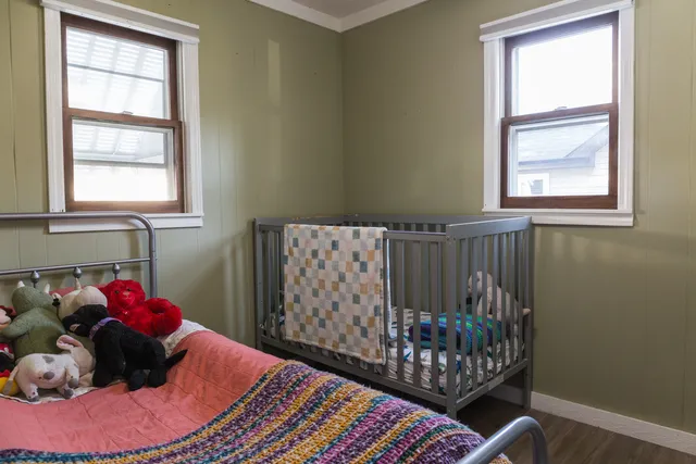 a bedroom with a bed and window