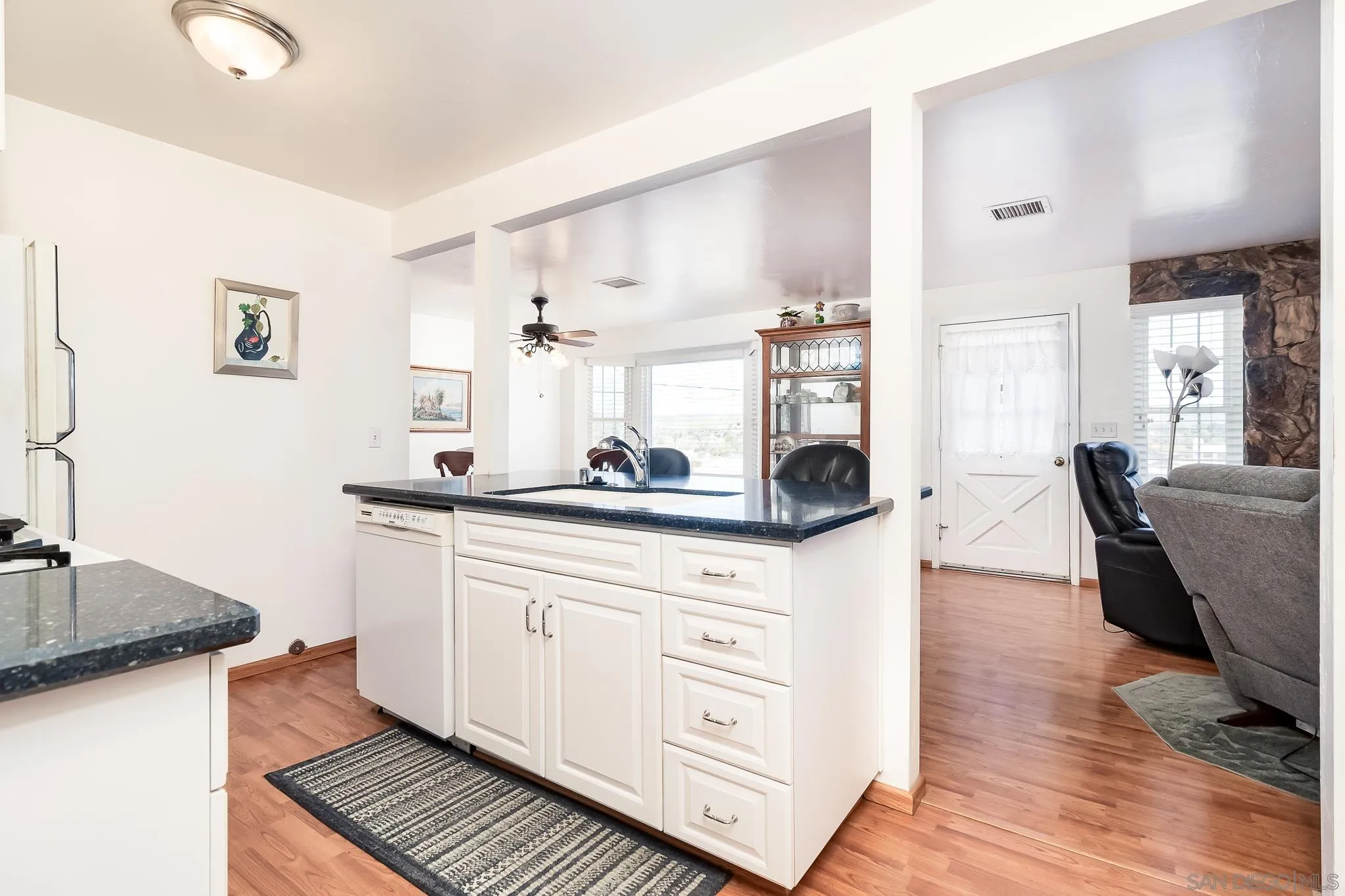 8423 Prospect Avenue Santee, CA 92071 - Photo 9 of 30 a kitchen with granite countertop a sink cabinets and wooden floor