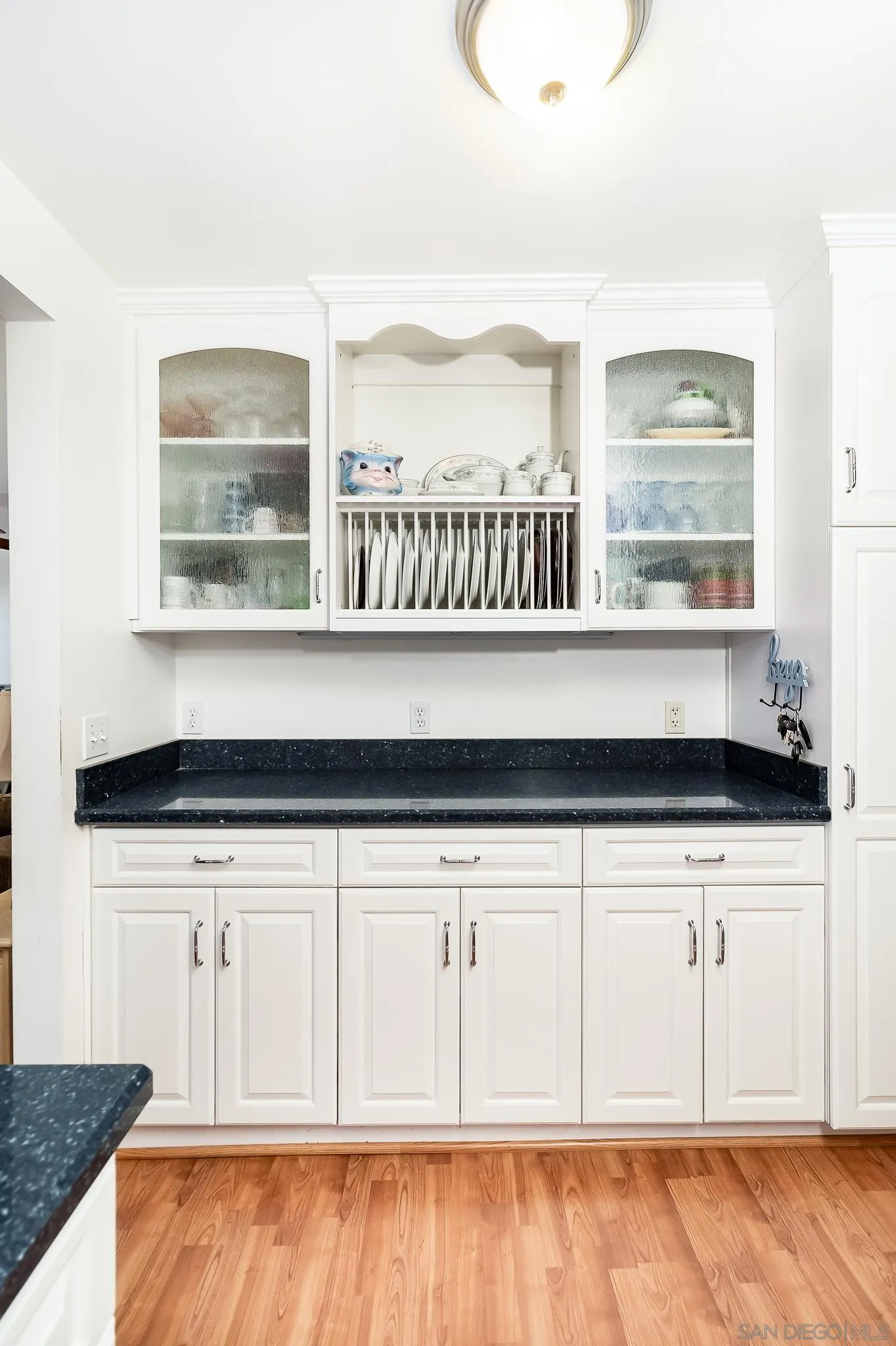 8423 Prospect Avenue Santee, CA 92071 - Photo 10 of 30 a kitchen with granite countertop a oven a cabinets and a wooden floor