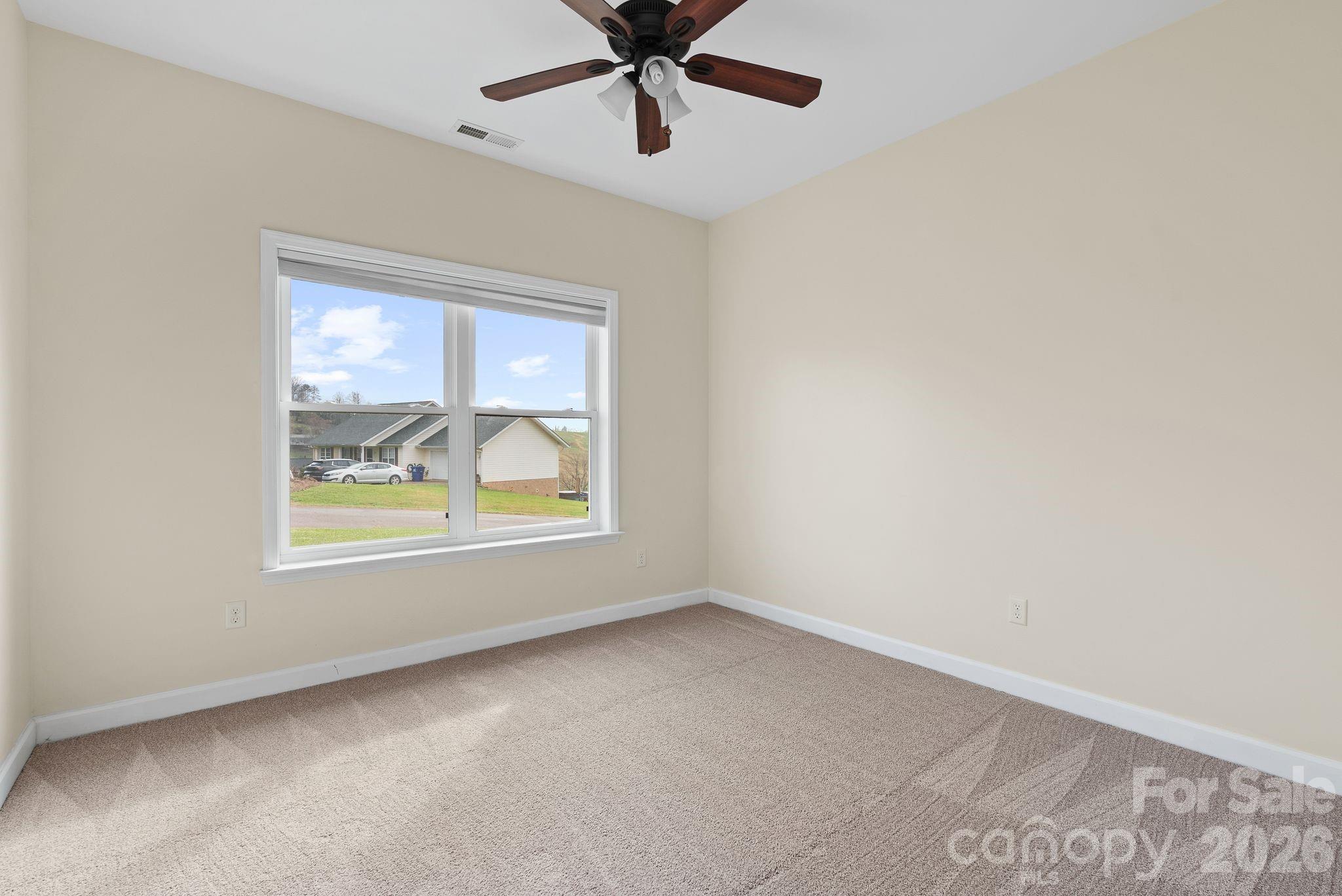 209 Breton Ridge Road Leicester, NC 28748 - Photo 12 of 34 an empty room with windows and fan