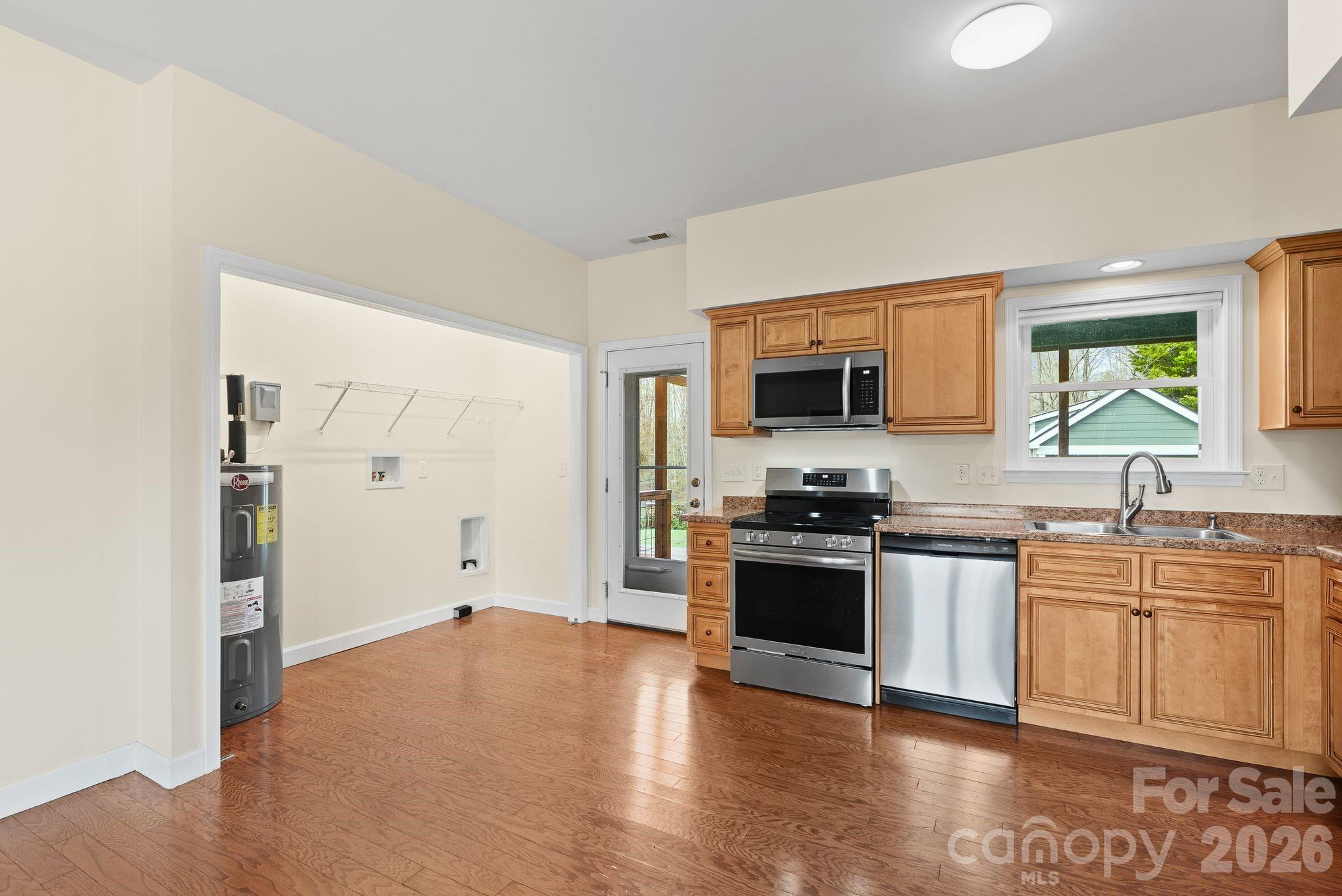 209 Breton Ridge Road Leicester, NC 28748 - Photo 16 of 34 a kitchen with stainless steel appliances granite countertop a stove and a sink