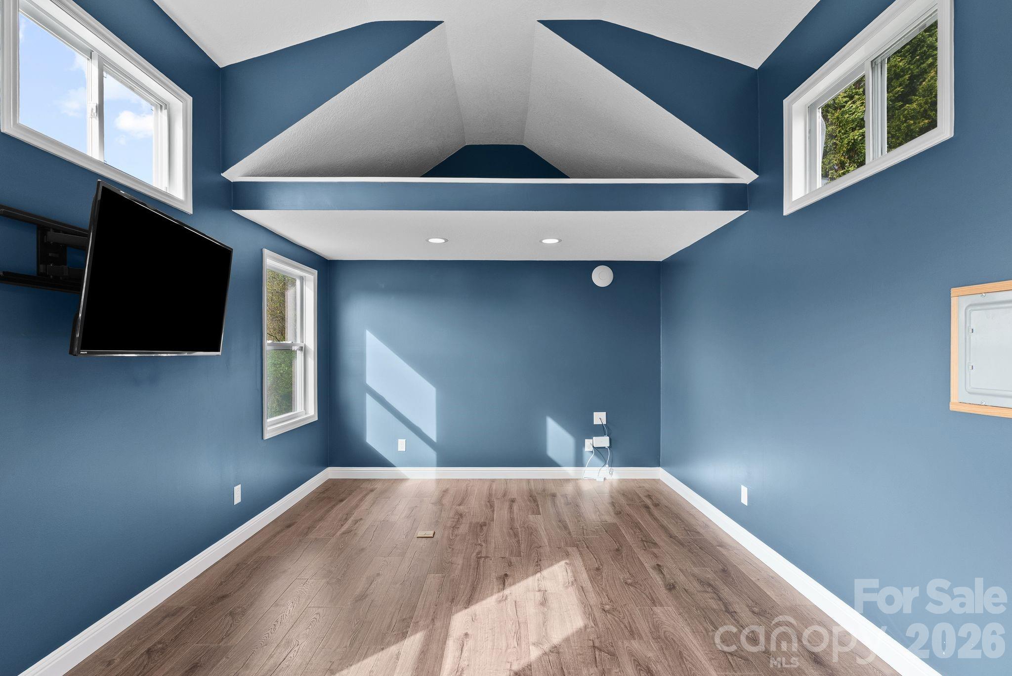 209 Breton Ridge Road Leicester, NC 28748 - Photo 20 of 34 a bedroom with a bed and a flat screen tv