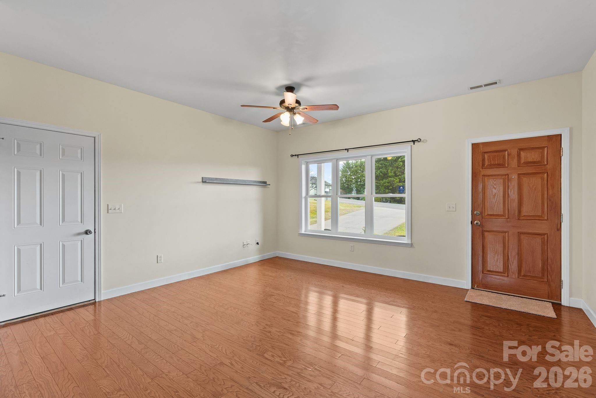 209 Breton Ridge Road Leicester, NC 28748 - Photo 8 of 34 a view of empty room with wooden floor and fan