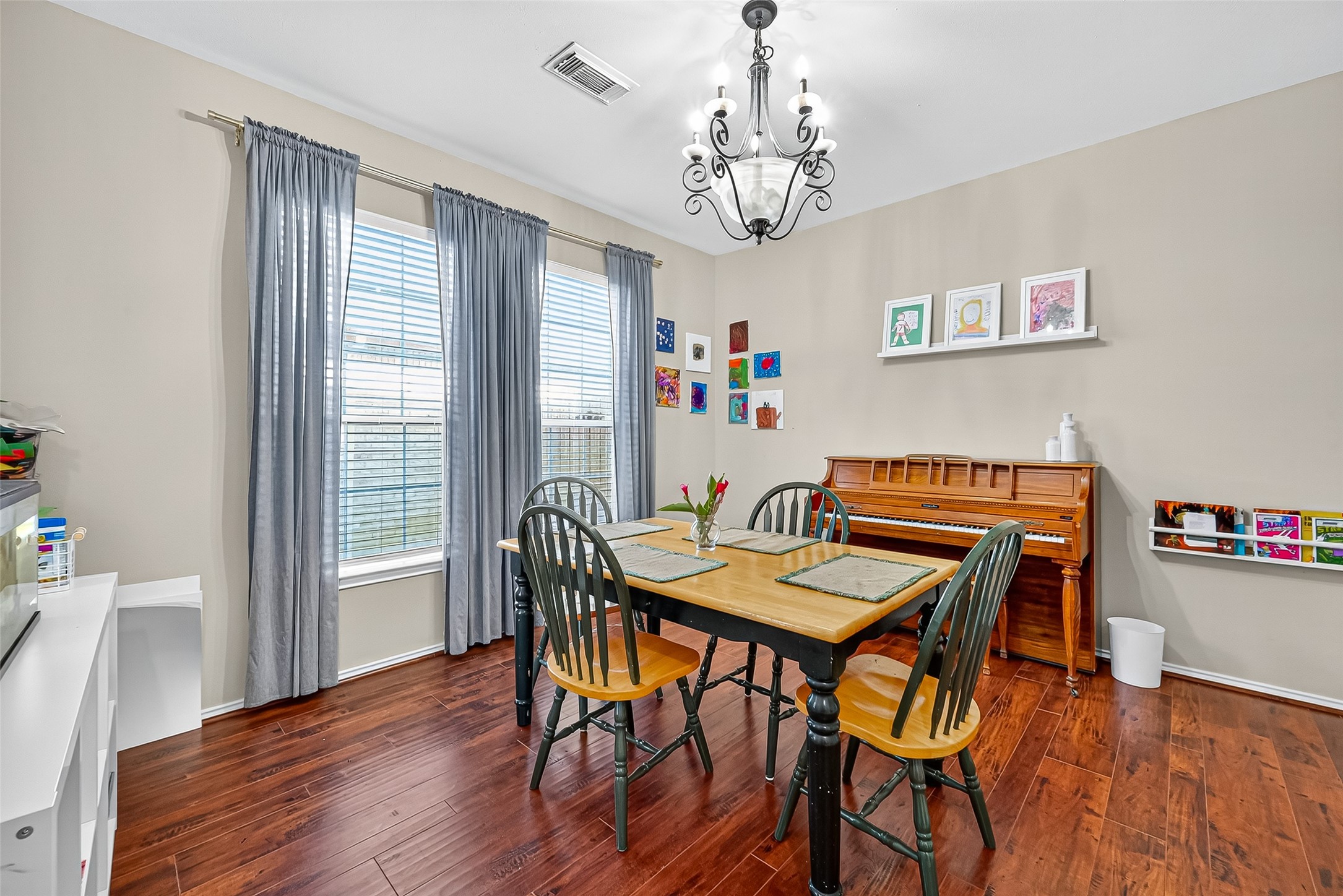 6019 Gablestone Lane Katy, TX 77450 - Photo 3 of 29 a view of a dining room with furniture wooden floor and a chandelier