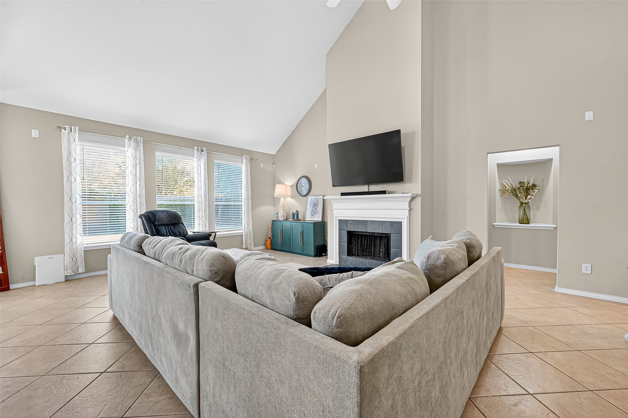 6019 Gablestone Lane Katy, TX 77450 - Photo 5 of 29 a living room with furniture a fireplace and a flat screen tv