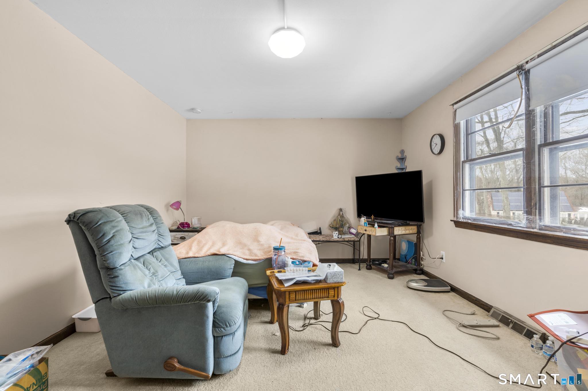 133 Stevenson Road Meriden, CT 06451 - Photo 21 of 30 a living room with furniture and a flat screen tv
