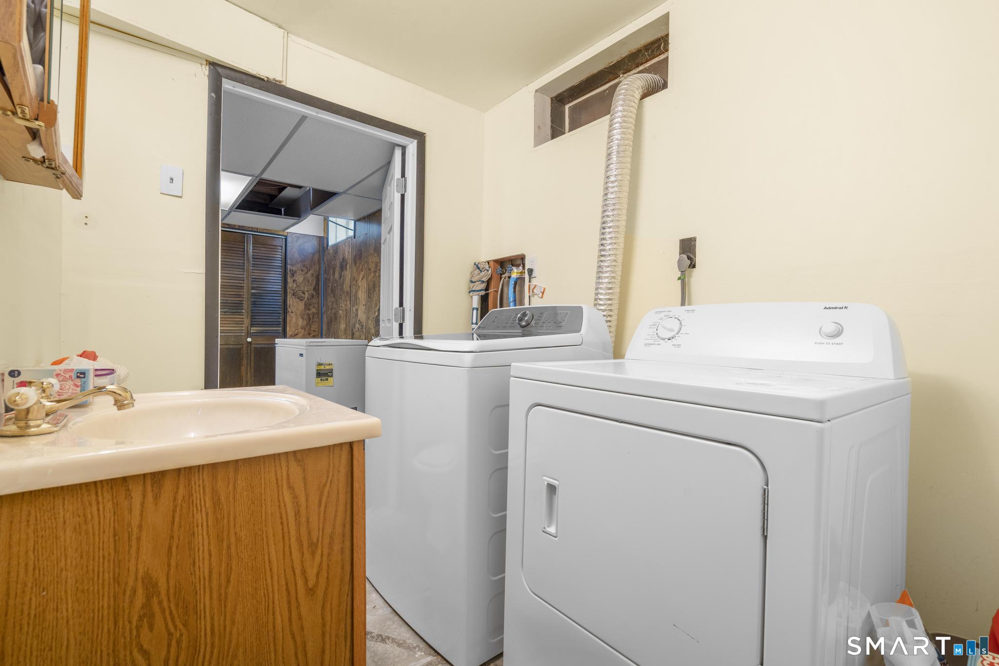 133 Stevenson Road Meriden, CT 06451 - Photo 25 of 30 a view of washer and dryer with kitchen in the background