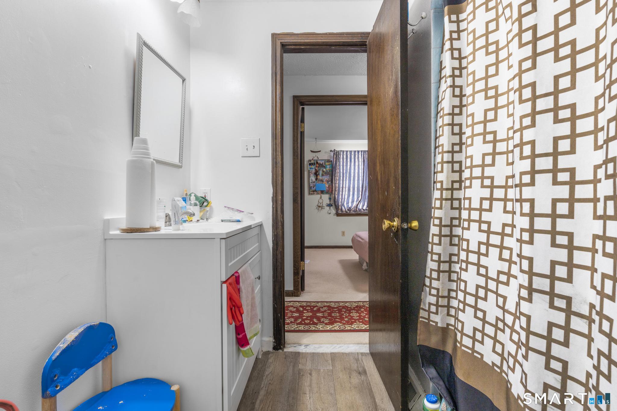 133 Stevenson Road Meriden, CT 06451 - Photo 29 of 30 a view of hallway with wooden floor and furniture