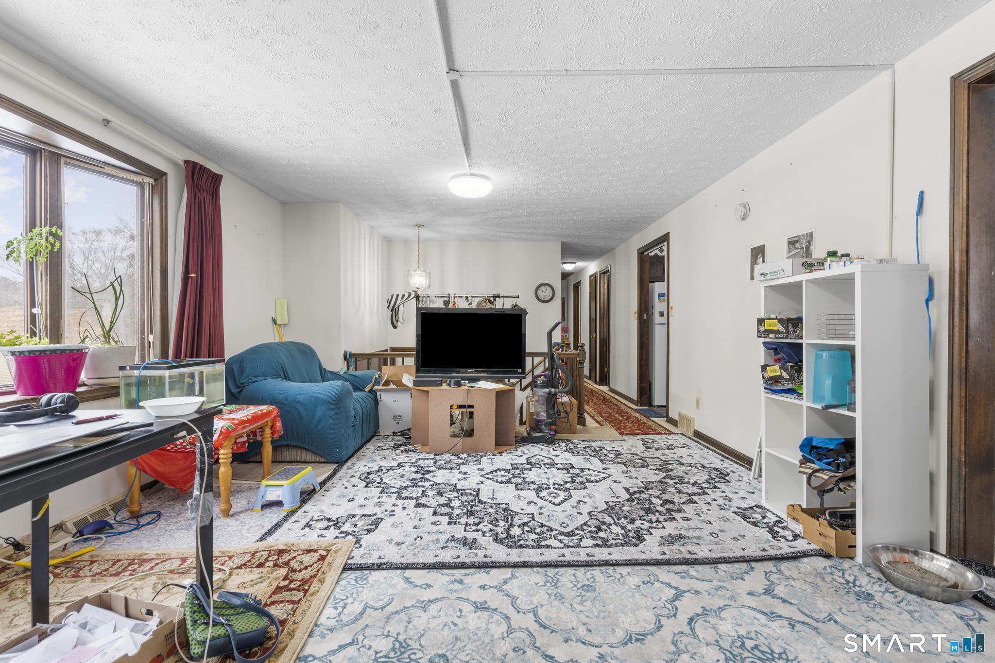 133 Stevenson Road Meriden, CT 06451 - Photo 7 of 30 a living room with furniture and a flat screen tv
