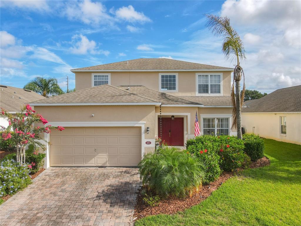 441 Balmoral Drive Davenport, FL 33896 - Photo 1 of 1 a front view of a house with a yard and garage