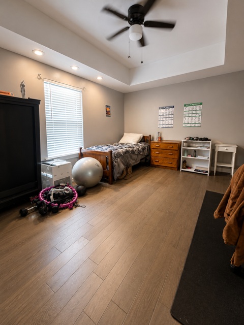 221 Winding Way Road Marble Falls, TX 78654 - Photo 7 of 19 A well-lit bedroom features durable flooring and a functional ceiling fan.