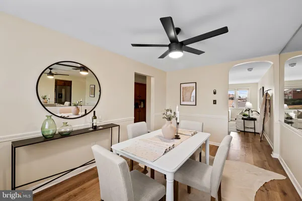 a view of a dining room with furniture and a potted plant