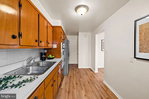 a kitchen with a sink a counter space and cabinets