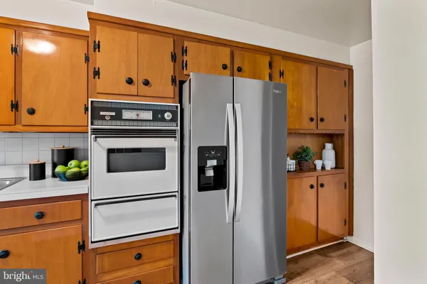 a kitchen with stainless steel appliances white cabinets and a refrigerator