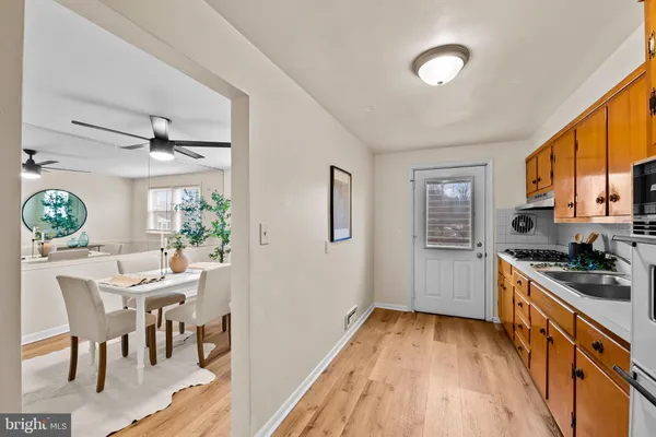 a kitchen with stainless steel appliances a stove a sink and a refrigerator
