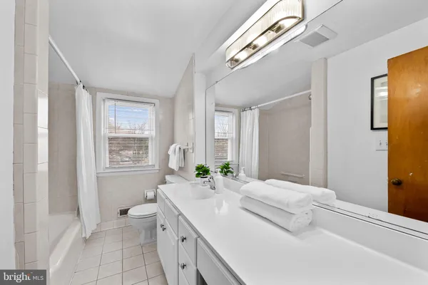 a spacious bedroom with a bed a couch and a window