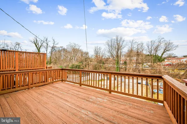a view of balcony with wooden floor and fence