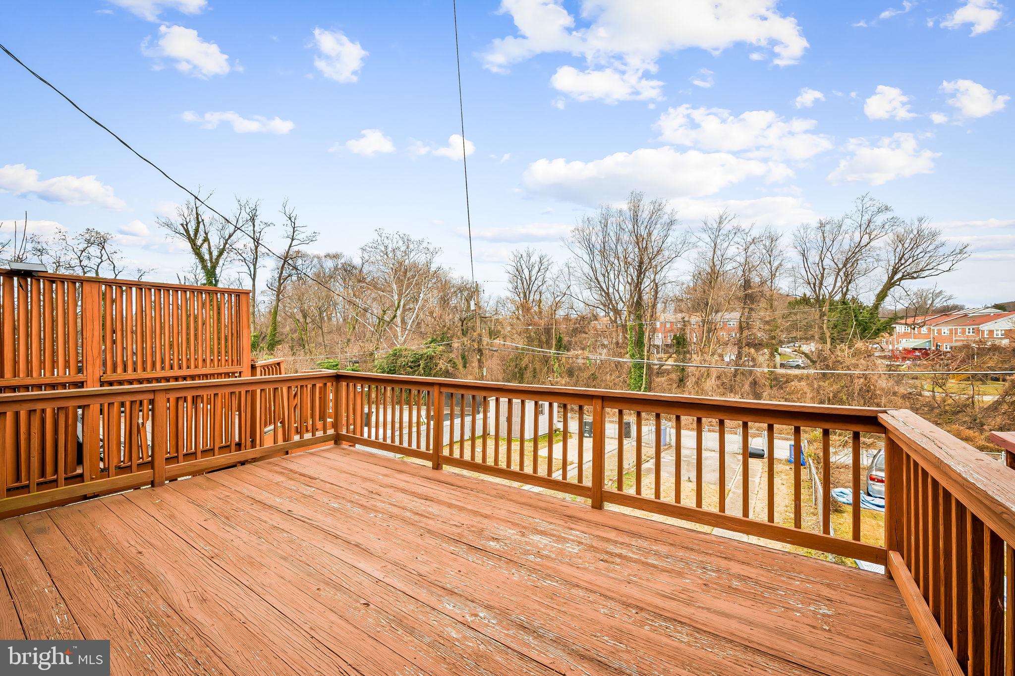1011 Linden Avenue Baltimore, MD 21227 - Photo 34 of 40 a view of balcony with wooden floor and fence