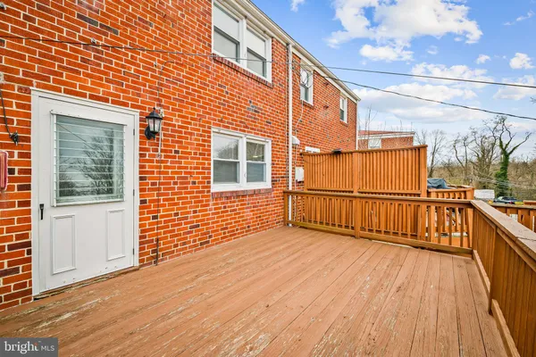 a view of a balcony with wooden floor and fence