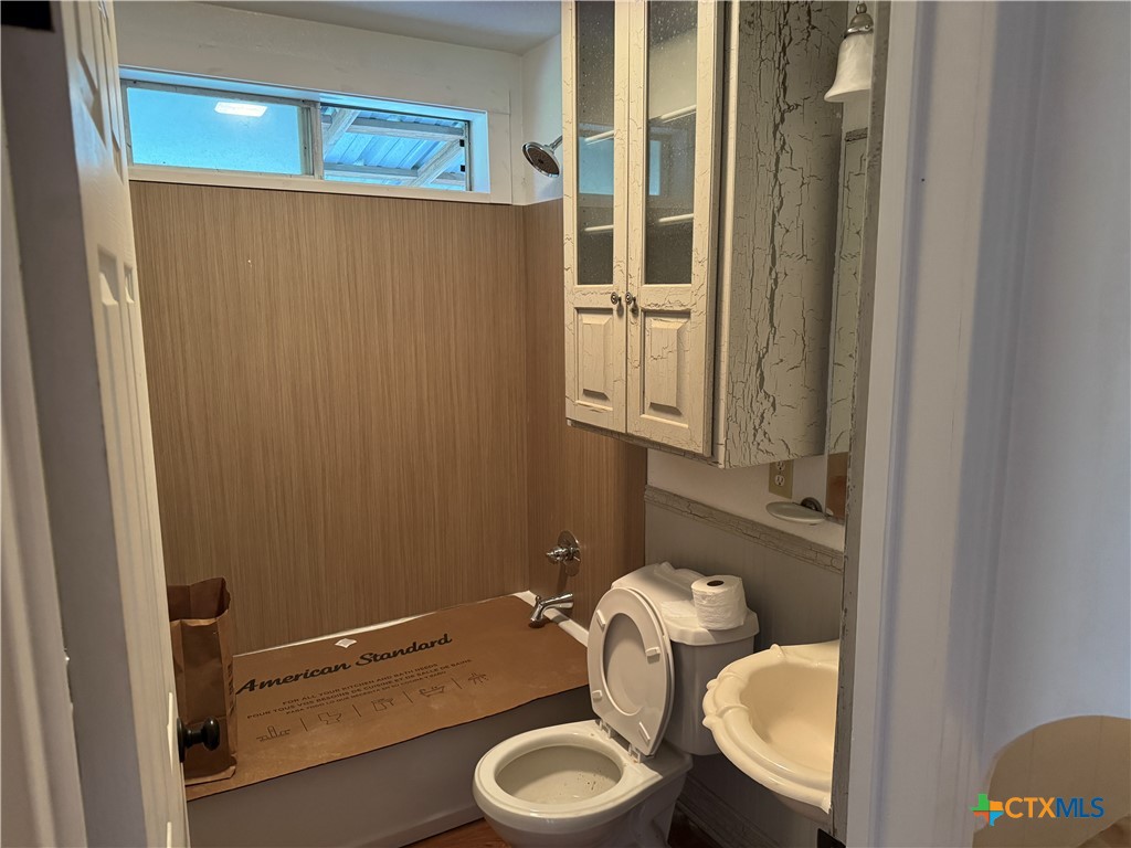 3510 Gun Club Road Temple, TX 76501 - Photo 13 of 17 a bathroom with a granite countertop toilet and a sink