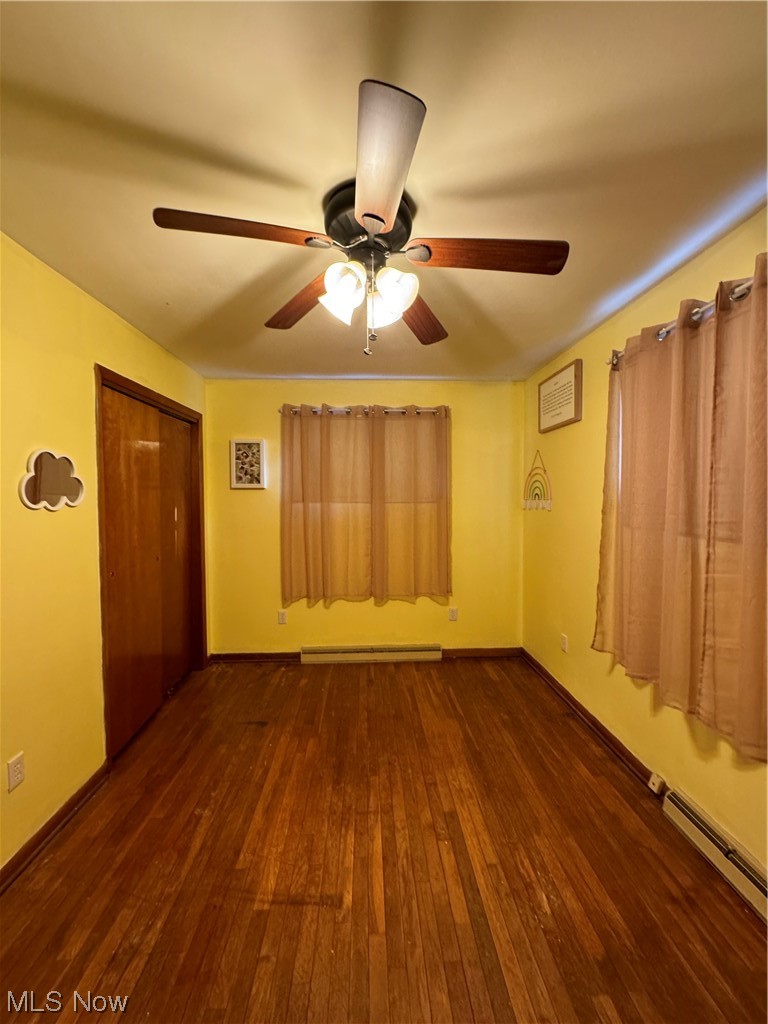 125 Sundale Road Norwich, OH 43767 - Photo 6 of 18 Empty room featuring dark hardwood / wood-style flooring, baseboard heating, and ceiling fan