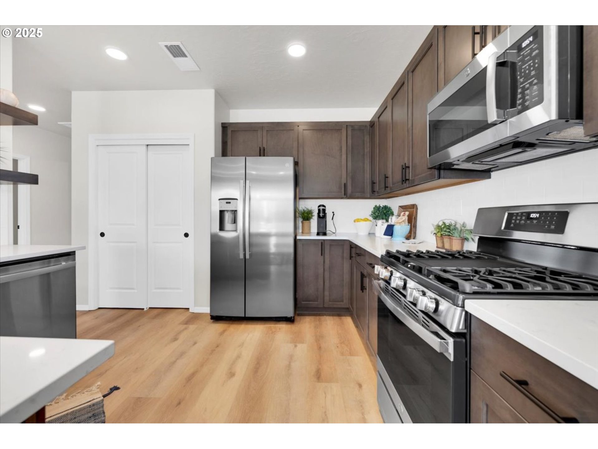 5190 Holly Street Springfield, OR 97478 - Photo 6 of 11 a kitchen with stainless steel appliances granite countertop a stove a refrigerator and a sink