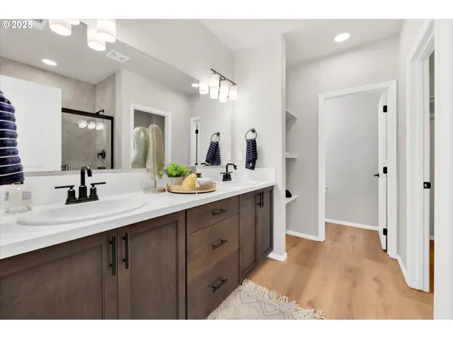 a bathroom with a double vanity sink mirror and