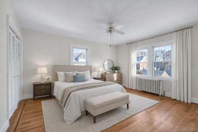 a bedroom with a bed wooden floor and a window