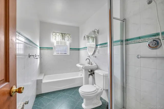 a bathroom with a toilet a sink and bathtub
