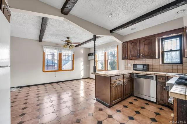 a kitchen with stainless steel appliances granite countertop a sink and cabinets