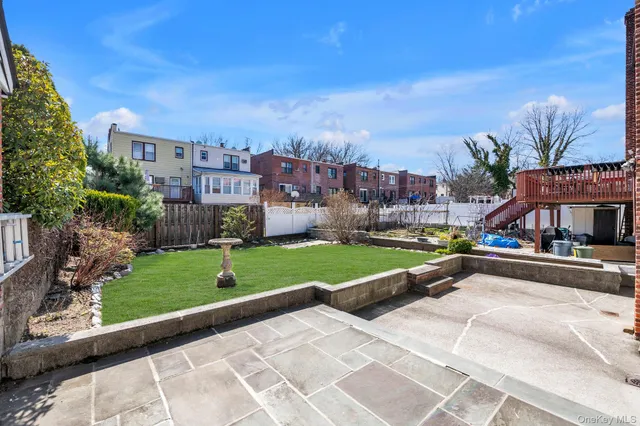 a view of a city with tall buildings and a big yard