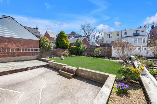 a view of backyard with outdoor seating and green space