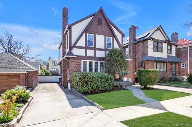 a front view of a house with a yard and potted plants