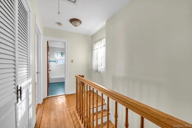 a view of hallway with wooden floor