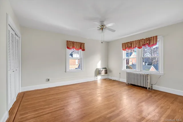 a view of room with window and wooden floor