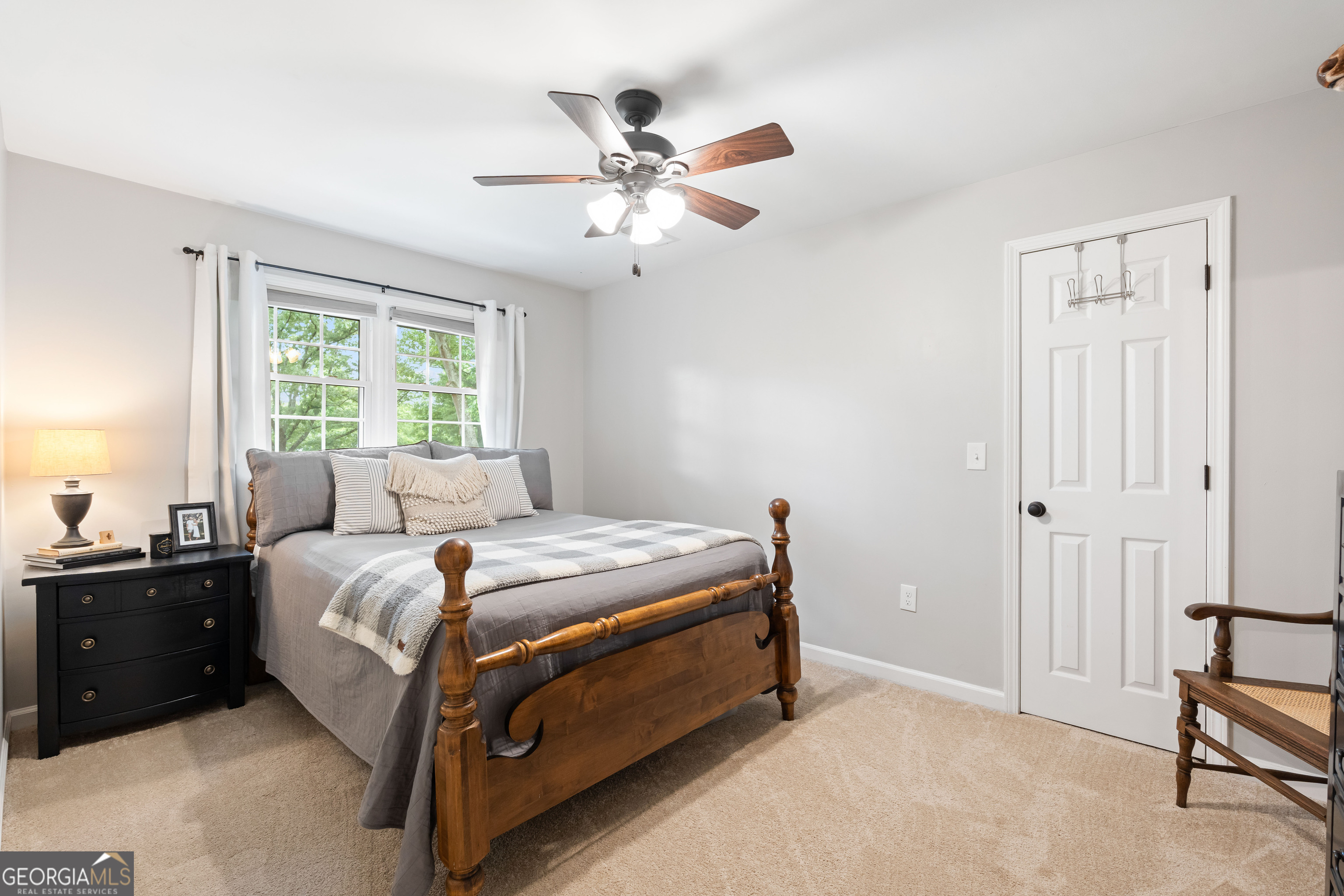 836 Oak Grove Road Carrollton, GA 30117 - Photo 41 of 50 a bedroom with a bed and a chandelier