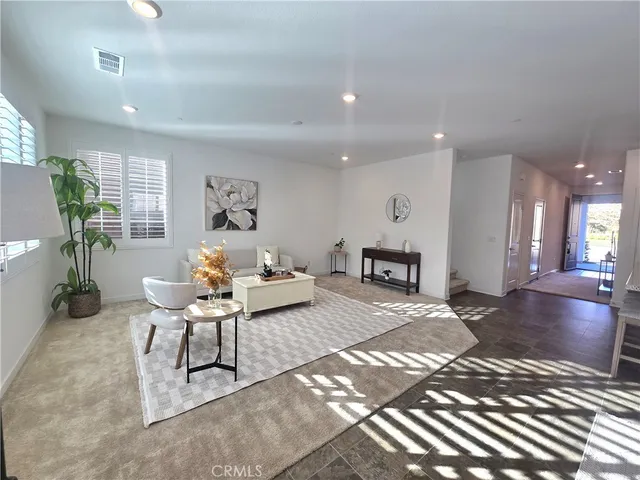 a living room with kitchen island granite countertop furniture and a potted plant
