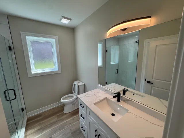 a bathroom with a sink mirror and toilet