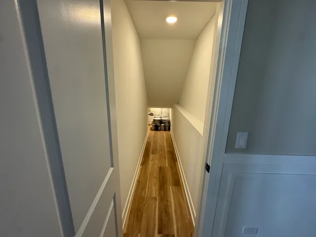 a view of a hallway with wooden floor
