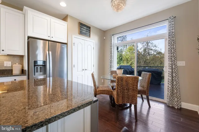 a large kitchen with stainless steel appliances granite countertop a lot of counter space and a sink