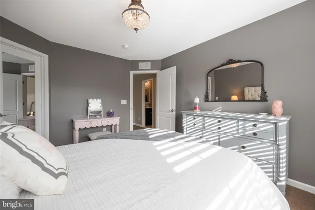 a bathroom with a sink a toilet a mirror and shower curtain