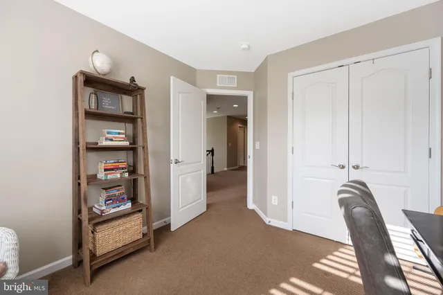 a spacious bedroom with a bed and a couch