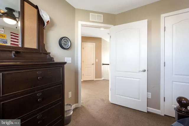 a spacious bathroom with a tub a double vanity sink and mirror