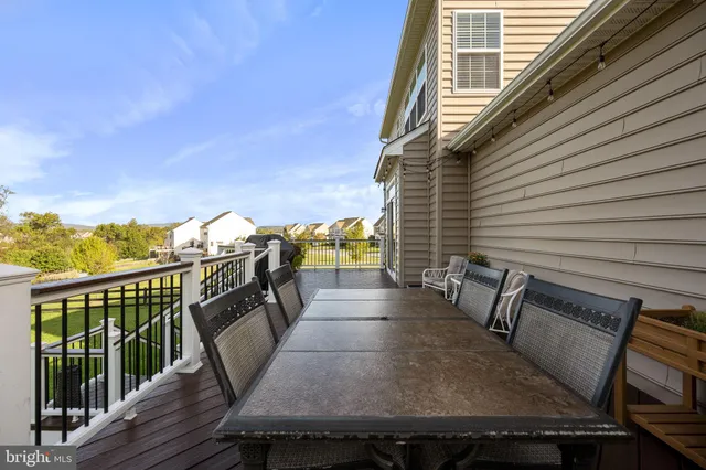 a view of a house with a big yard and a large tree with wooden fence